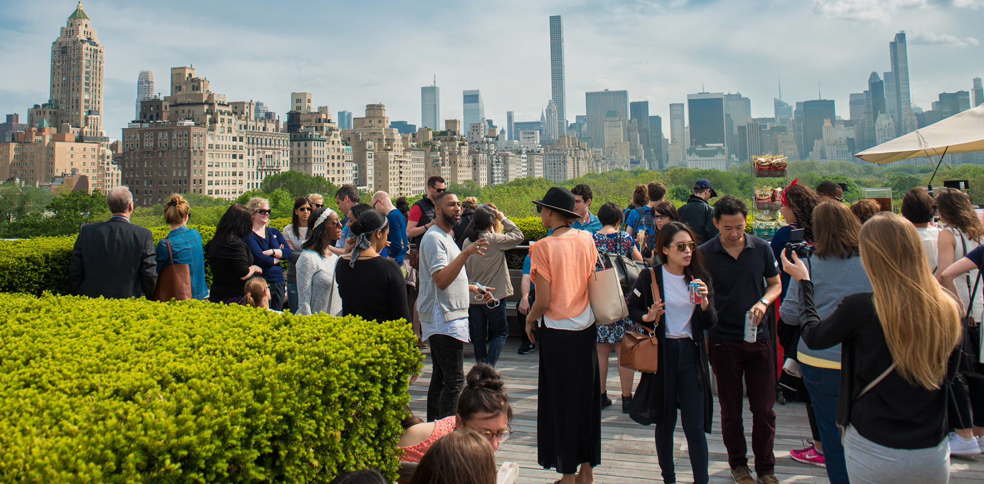 People chilling on rooftop with Manhattan and Central Park view
