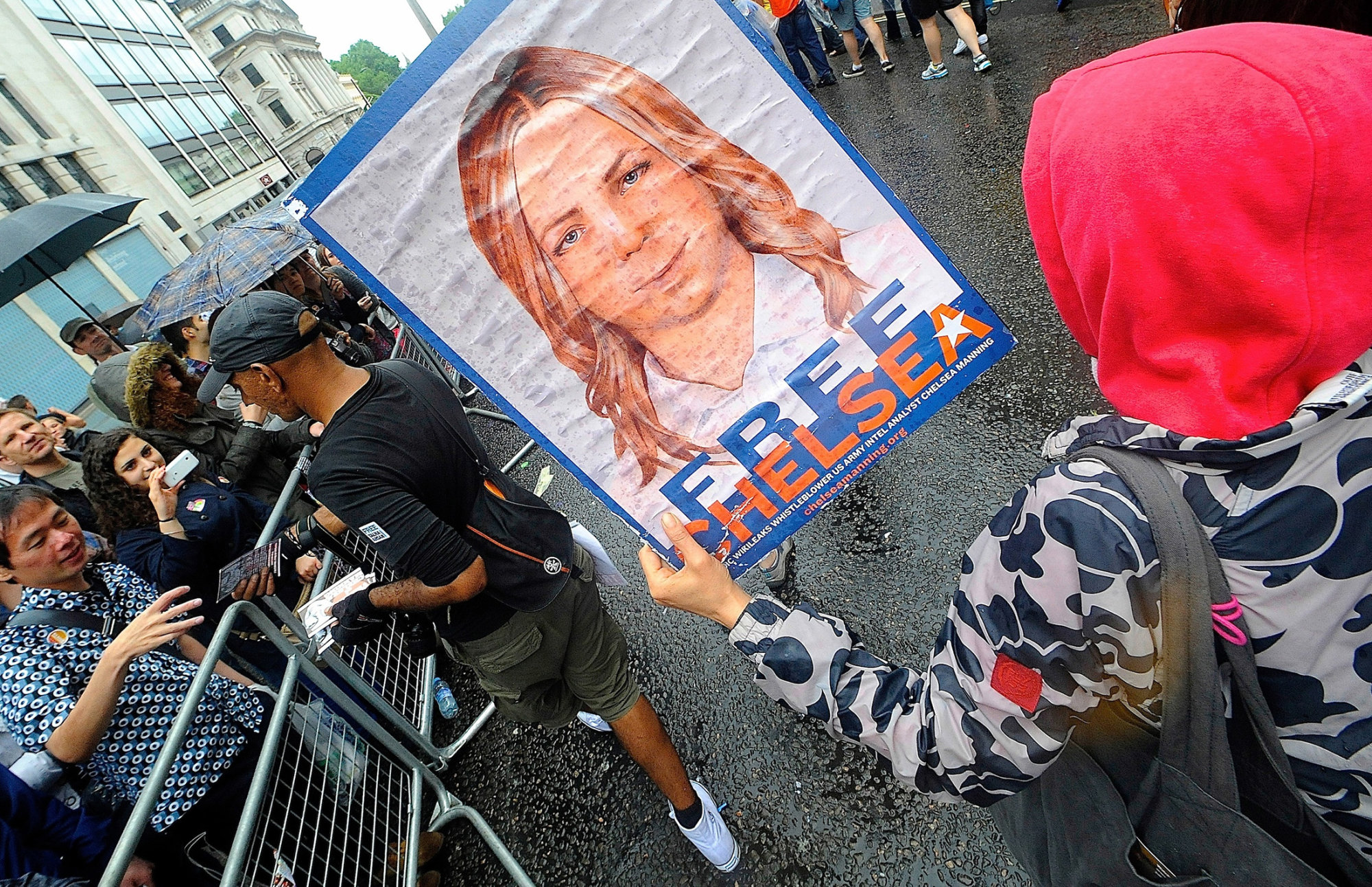 A supporter of Chelsea Manning holds a placard during a pride parade in London.
