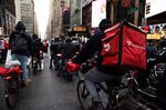 Demonstrators ride down 7th Avenue during a march for food delivery workers rights in New York, on April 21.