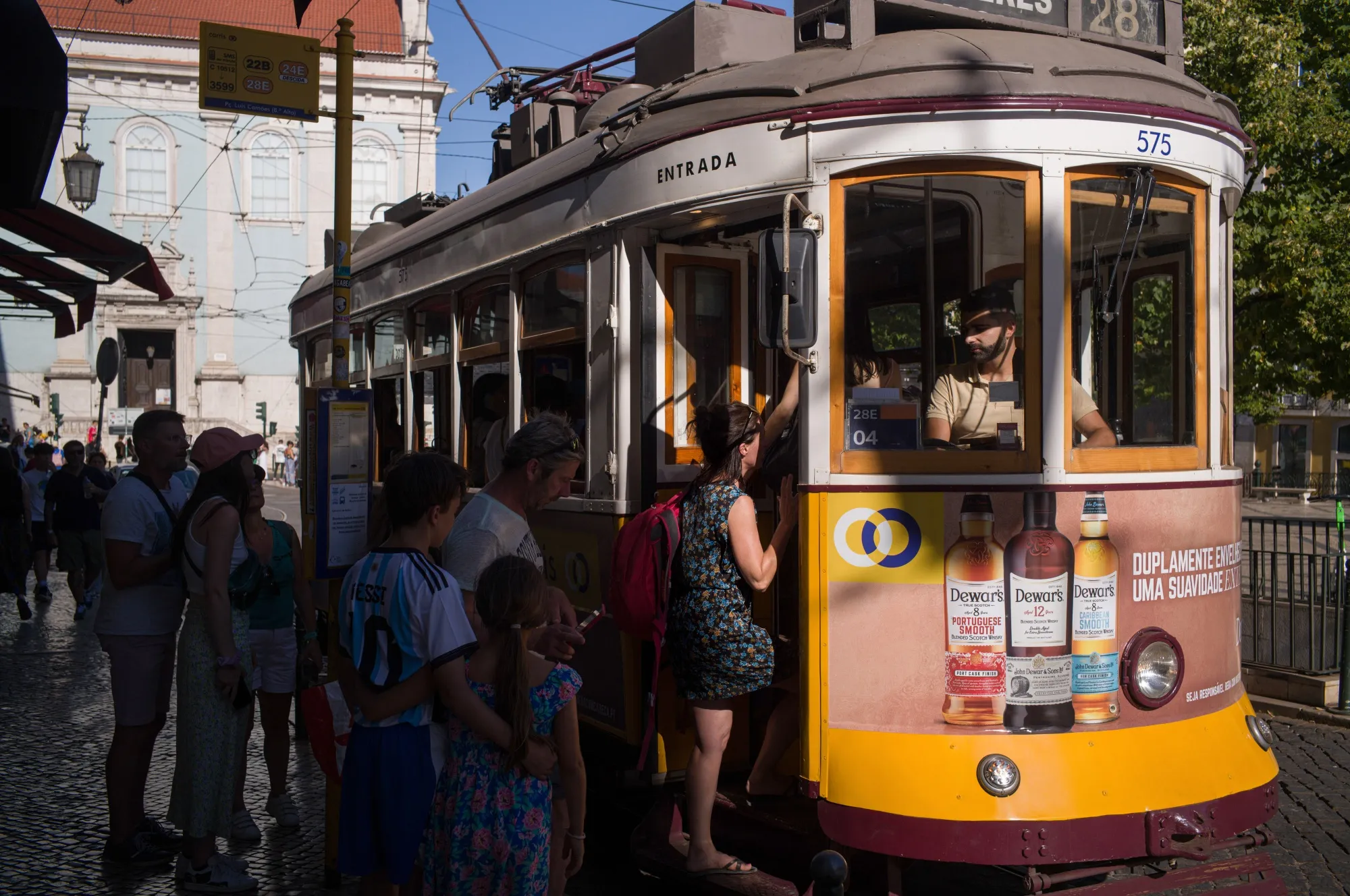 People board a tram in the Baixa district of Lisbon.