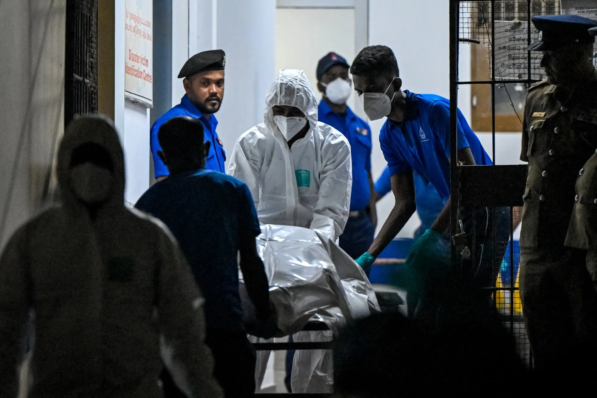 Healthcare workers carry the bodies of Iranian sailors who died in a US torpedo attack on their frigate IRIS Dena off Sri Lanka's southern coast.