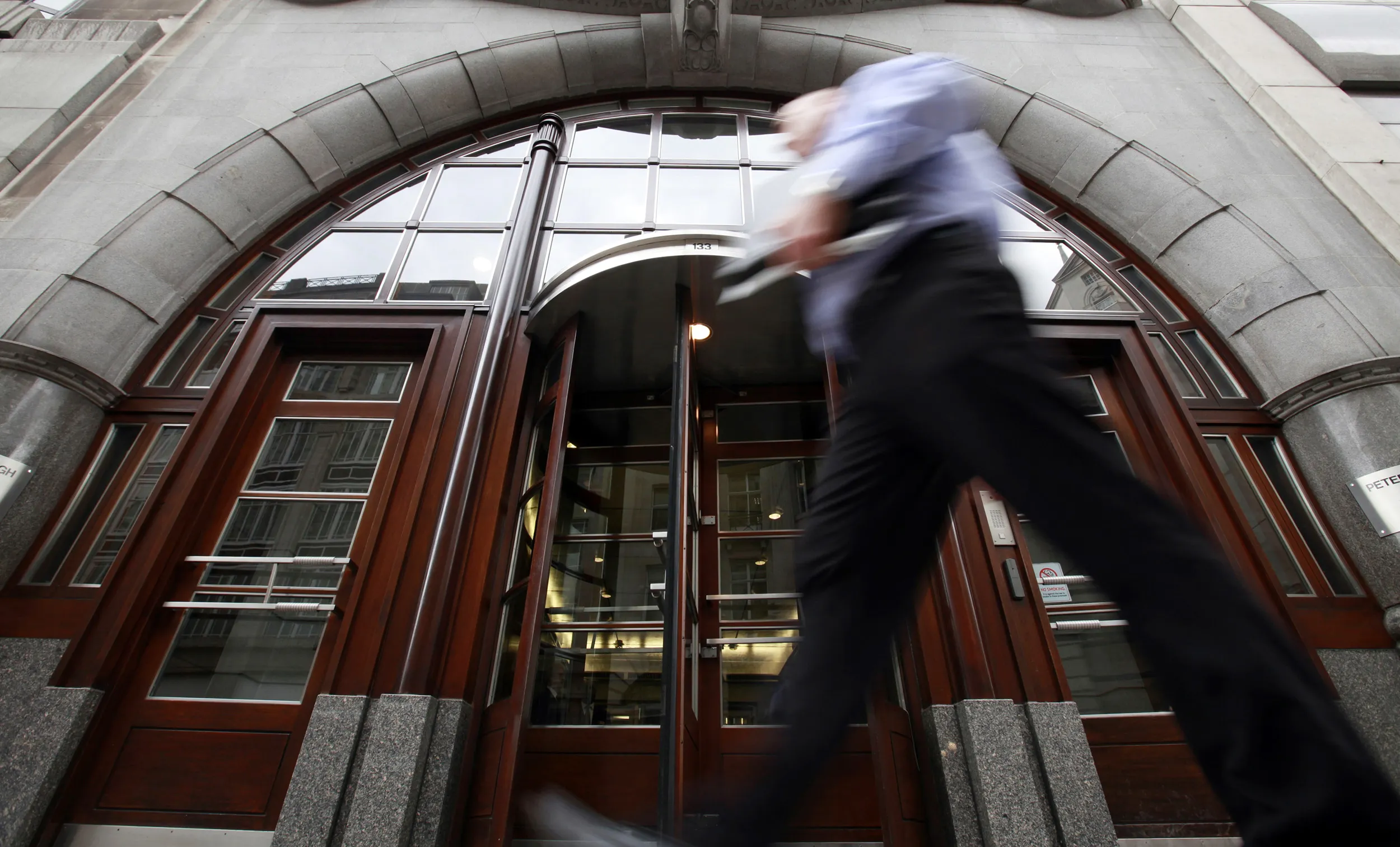 Pedestrians pass Mercury House, the main entrance to the Goldman Sachs offices at 133 Fleet Street in London.
