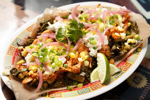 An elegant hybrid made of warmly spiced chicken with greens, pickled onions, fresh cheese, and hard-boiled egg.