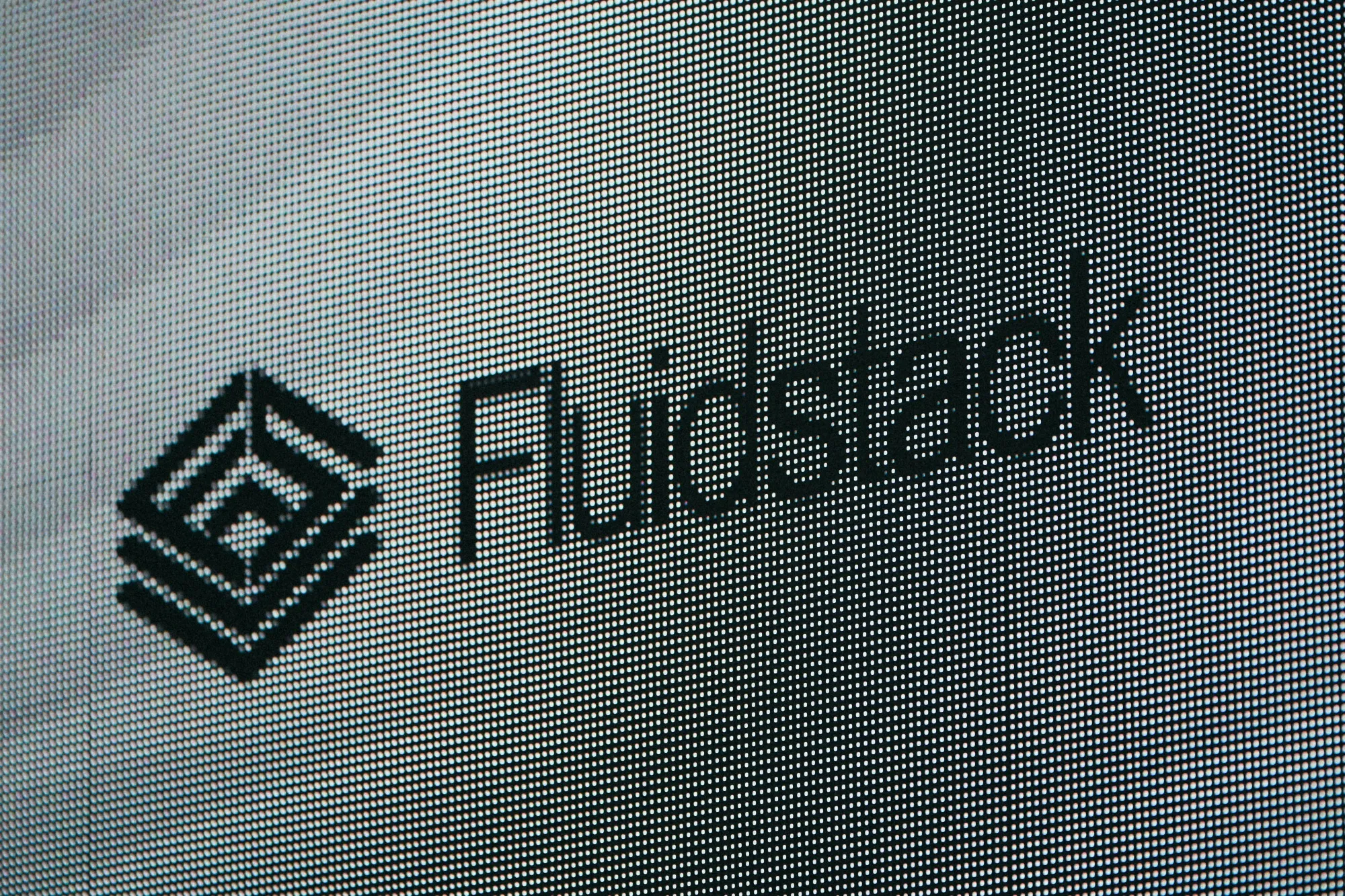 The Fluidstack logo on a screen at the Summit for action on AI in Paris.