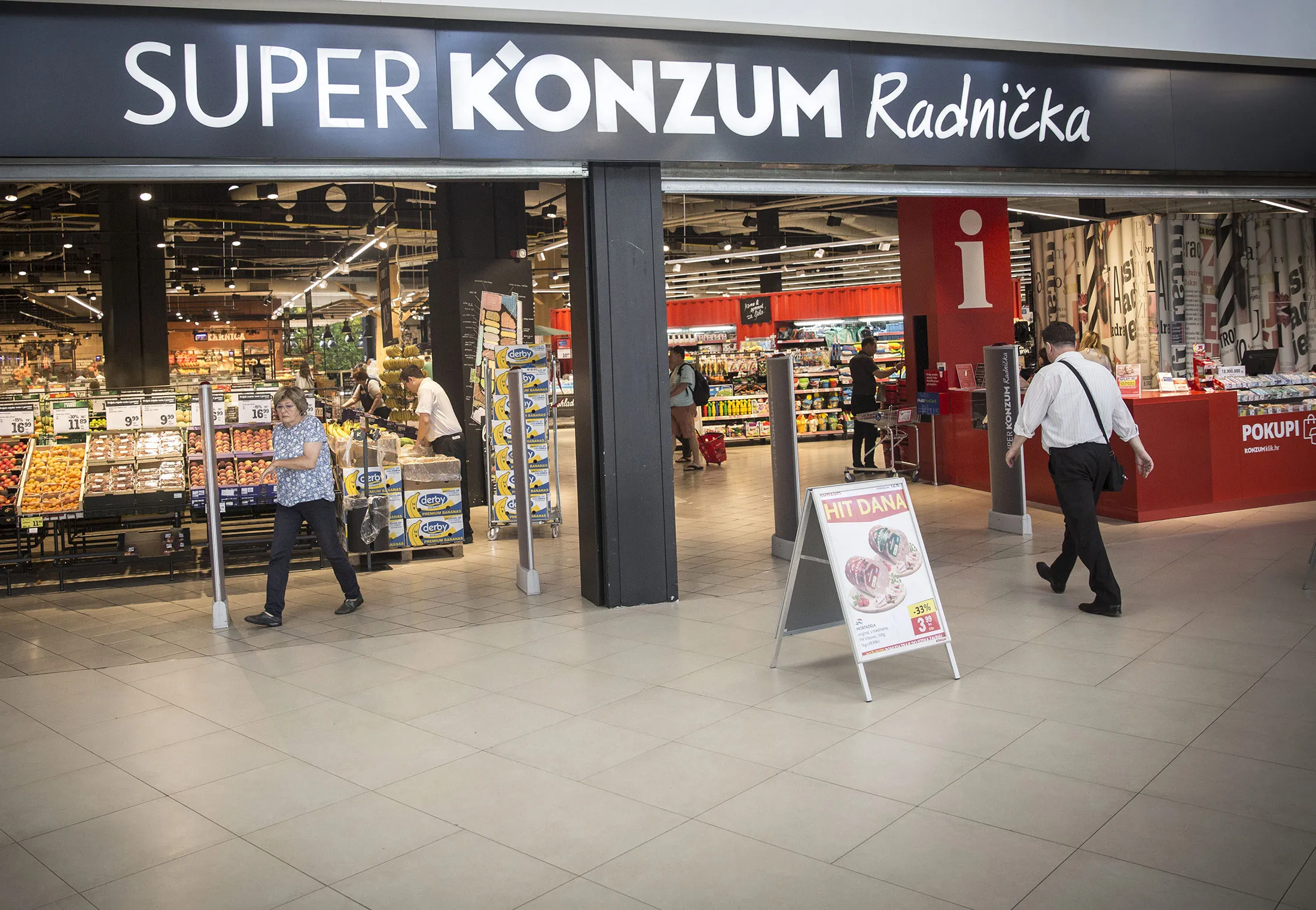 A customer enters the entrance to a Super Konzum supermarket, operated by Agrokor dd, in Zagreb.
