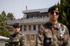 Tourists looking out from the Panmungak pavillion on the North Korean side of the border are seen from the South Korean side in the truce village of Panmunjom in the Demilitarized Zone (DMZ) .