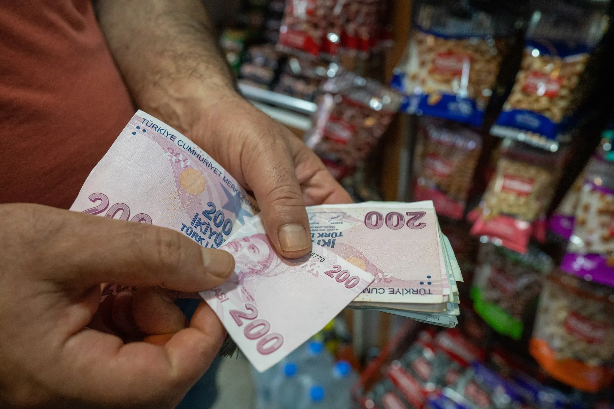 A person counts Turkish lira banknotes.