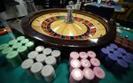 Gaming chips sit around a roulette wheel at the Japan Casino School in Tokyo, Japan.