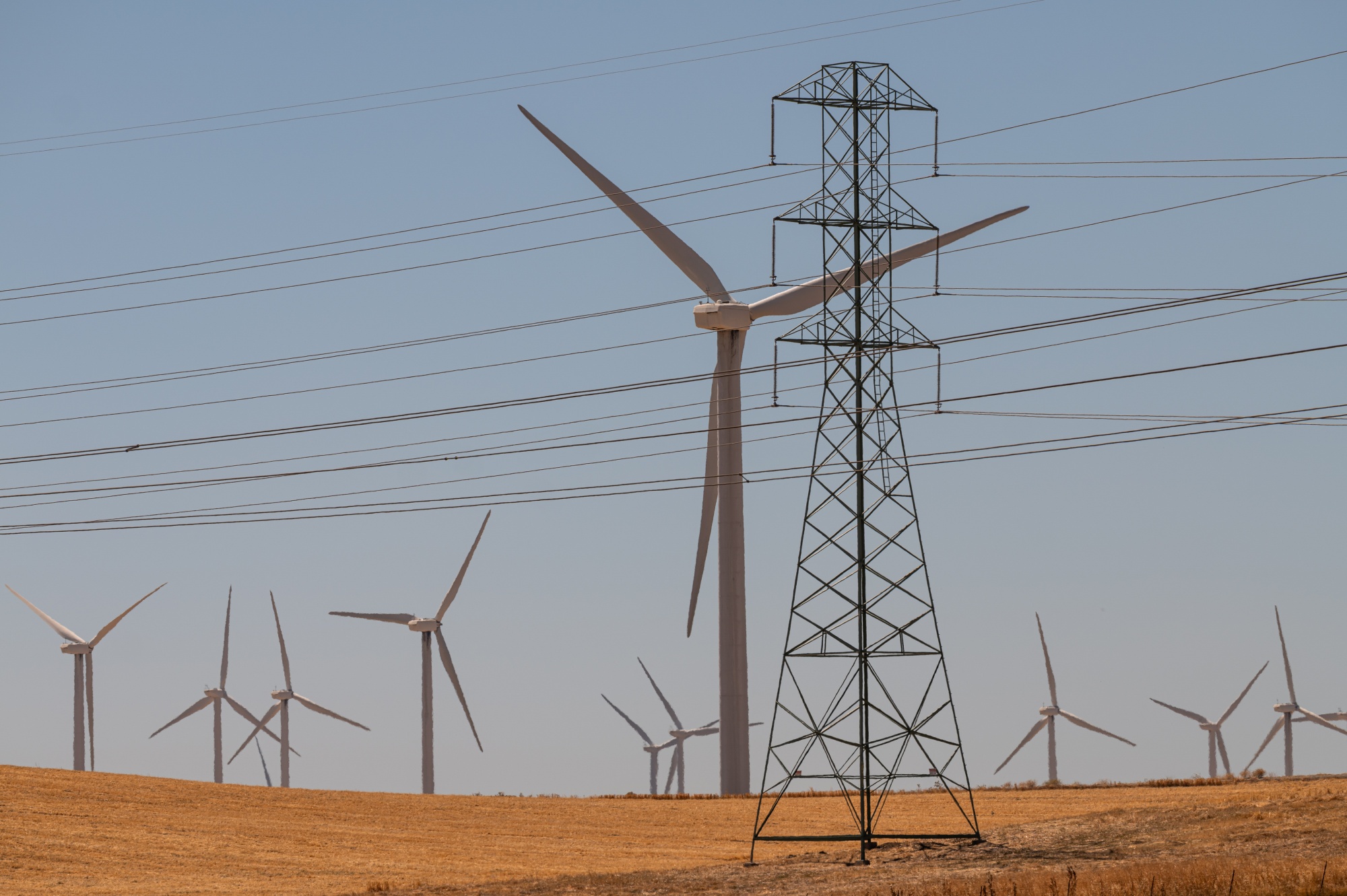 Power transmission lines and wind turbines in Rio Vista, California.