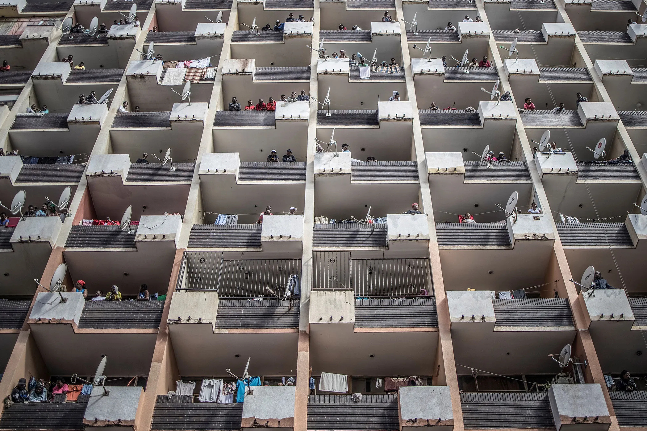 Residents of a Hillbrow building observe from the balconies in Johannesburg on March 28.