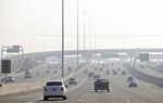 Cars make their way along a highway in heavy smog south of downtown Salt Lake City in Utah, U.S., on Monday, Jan. 11, 2010. 