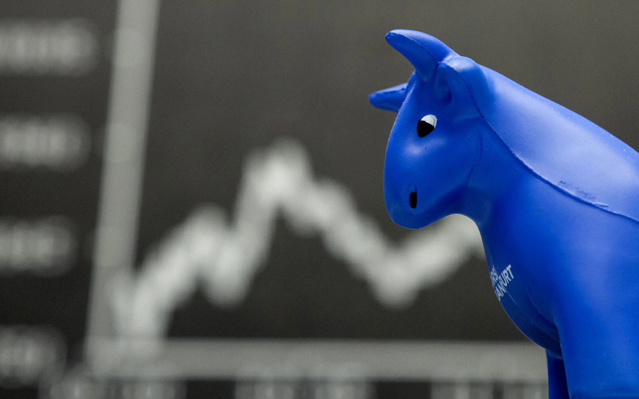 A toy bull figurine sits on a financial trader's desk.
