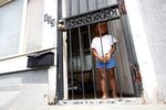 A young boy stands in the door of his home in Gary, Indiana. 