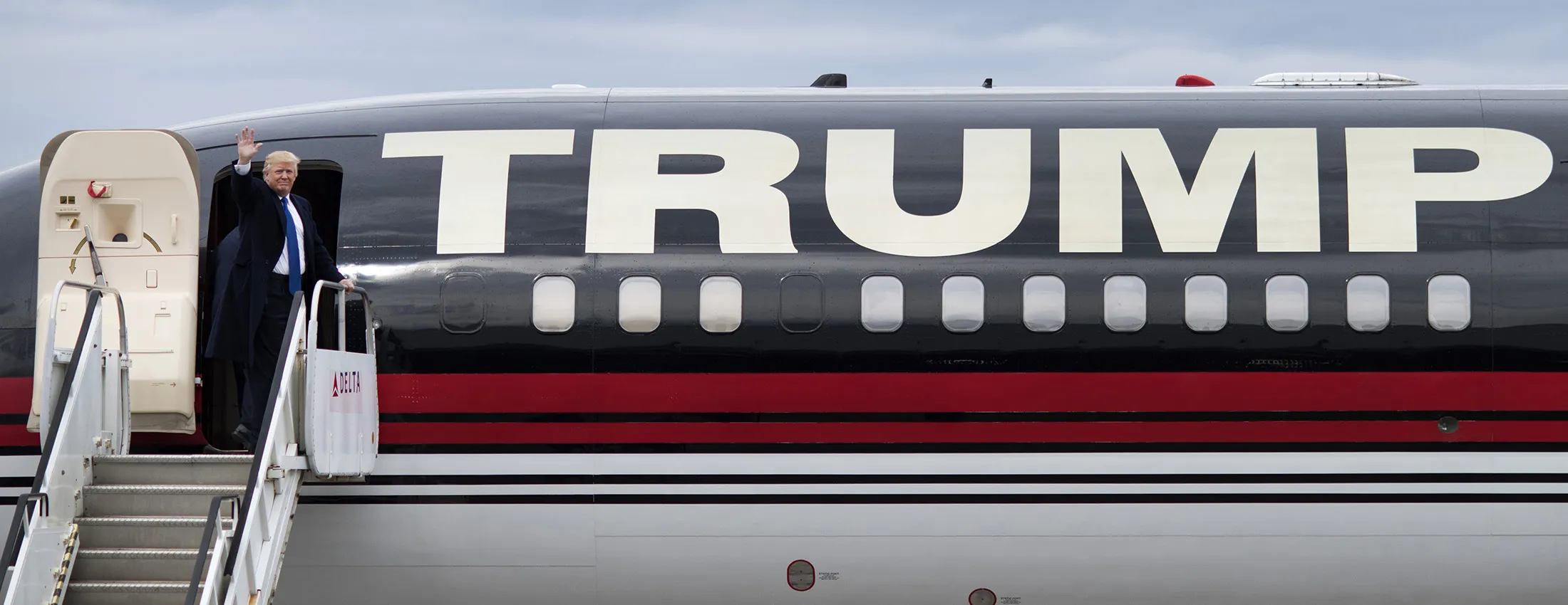 Donald Trump waves while boarding the Trump plane after a campaign rally at the Port Columbus International Airport in Columbus, Ohio, on March 1, 2016.
