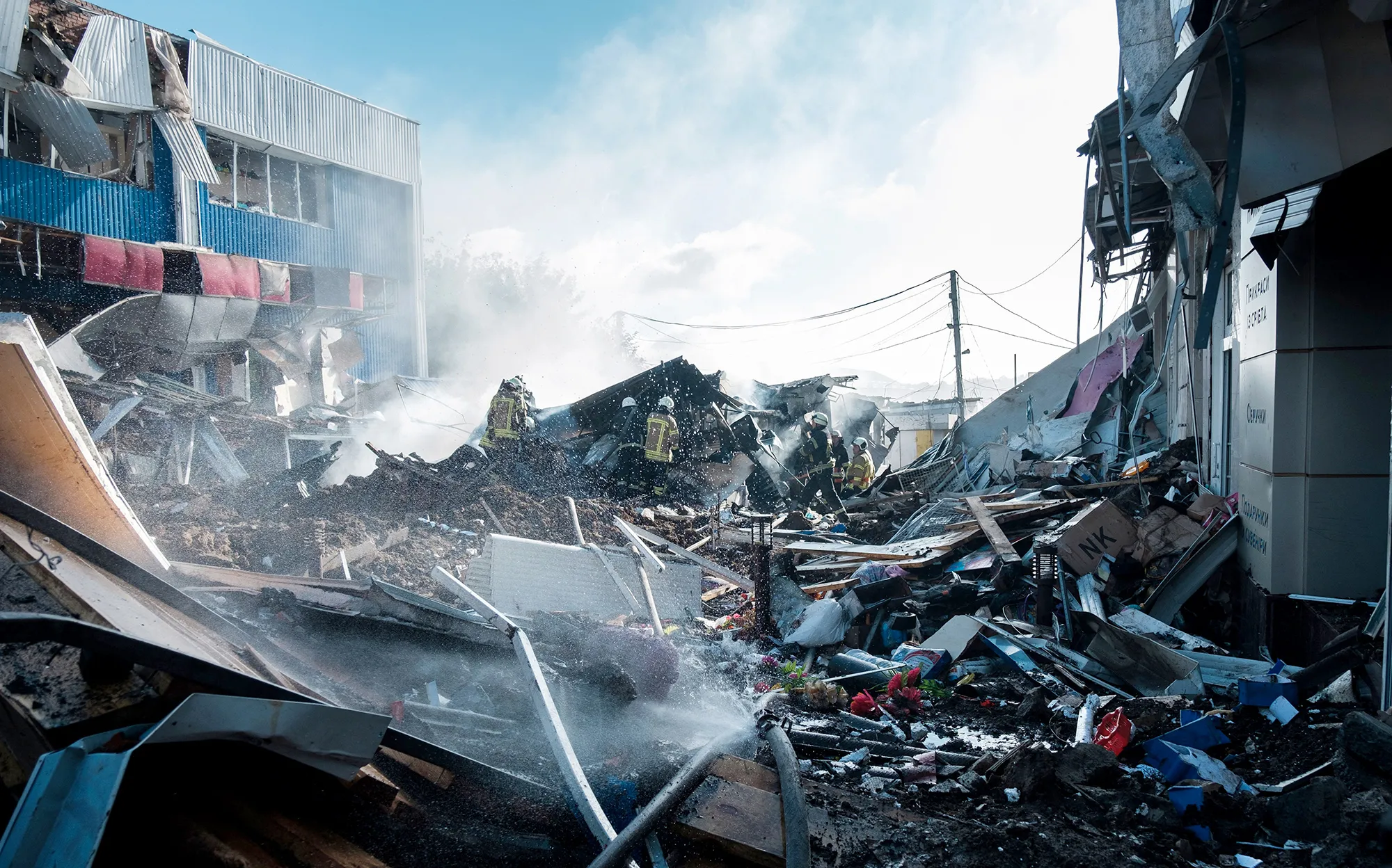 Firefighters extinguish a fire on a local market following&nbsp;shelling in the town of Bakhmut, eastern Ukraine, on July 21.