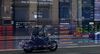 A motorcyclist is reflected in a window as electronic boards display stock information at the Australian Securities Exchange, operated by ASX Ltd., in Sydney, Australia.