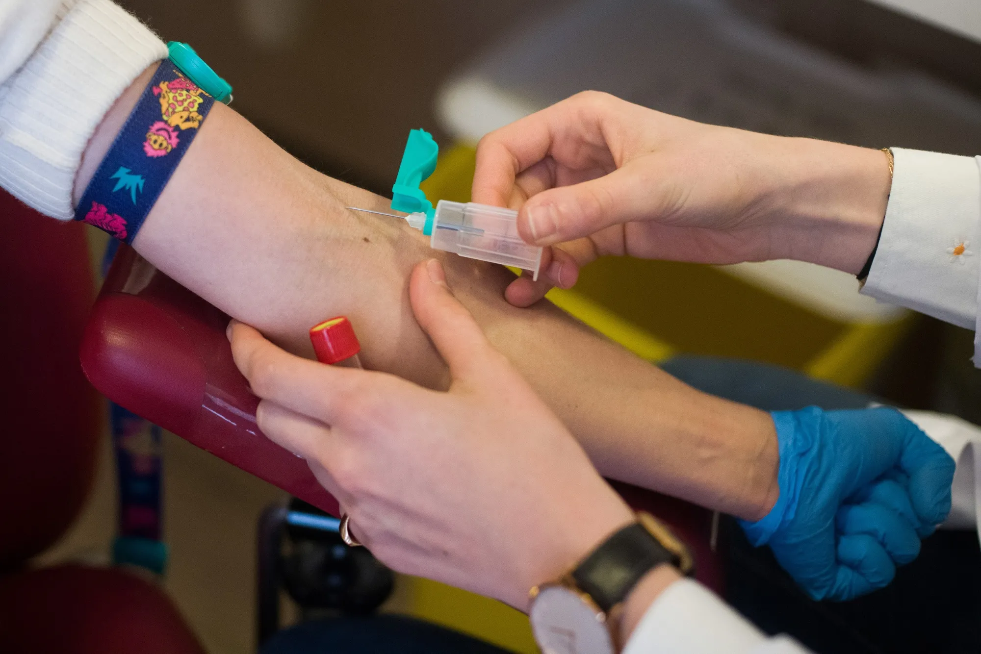 A medic takes a patient's blood sample at a coronavirus testing lab in Paris.