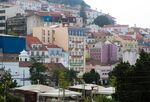 Residential properties stand on the hill leading to Saint George’s hilltop castle in Lisbon.
