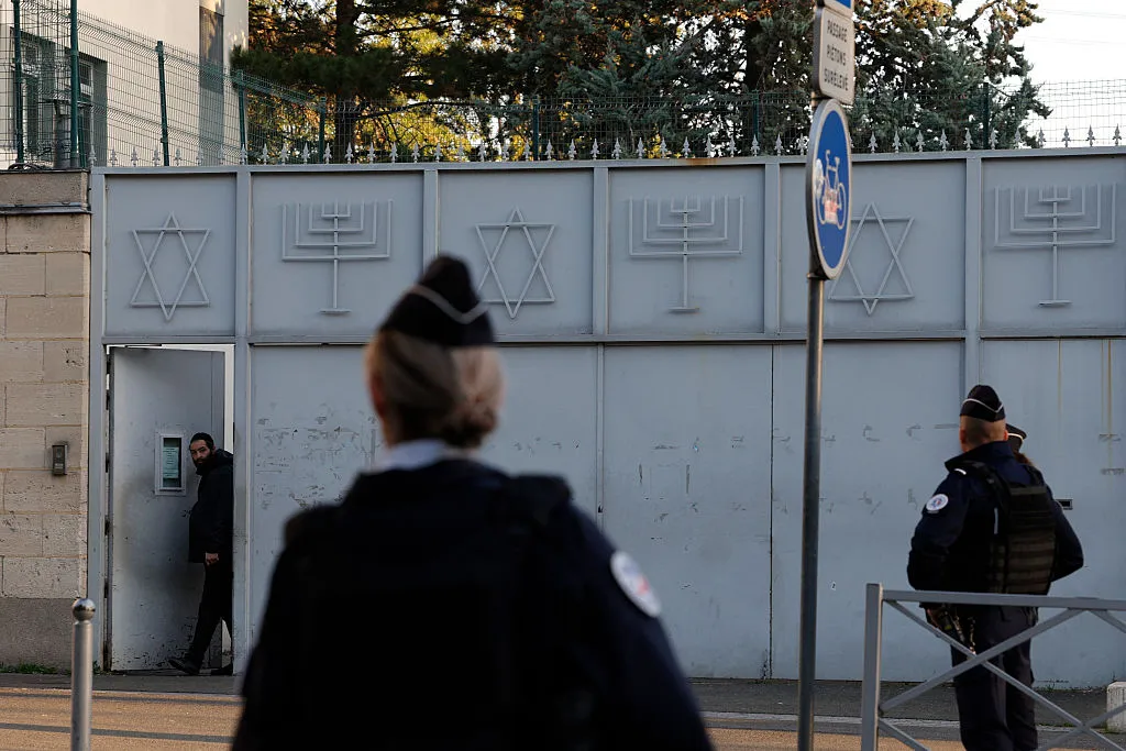 French police officers stand guard in front of a synagogue, in Paris’s suburbs.