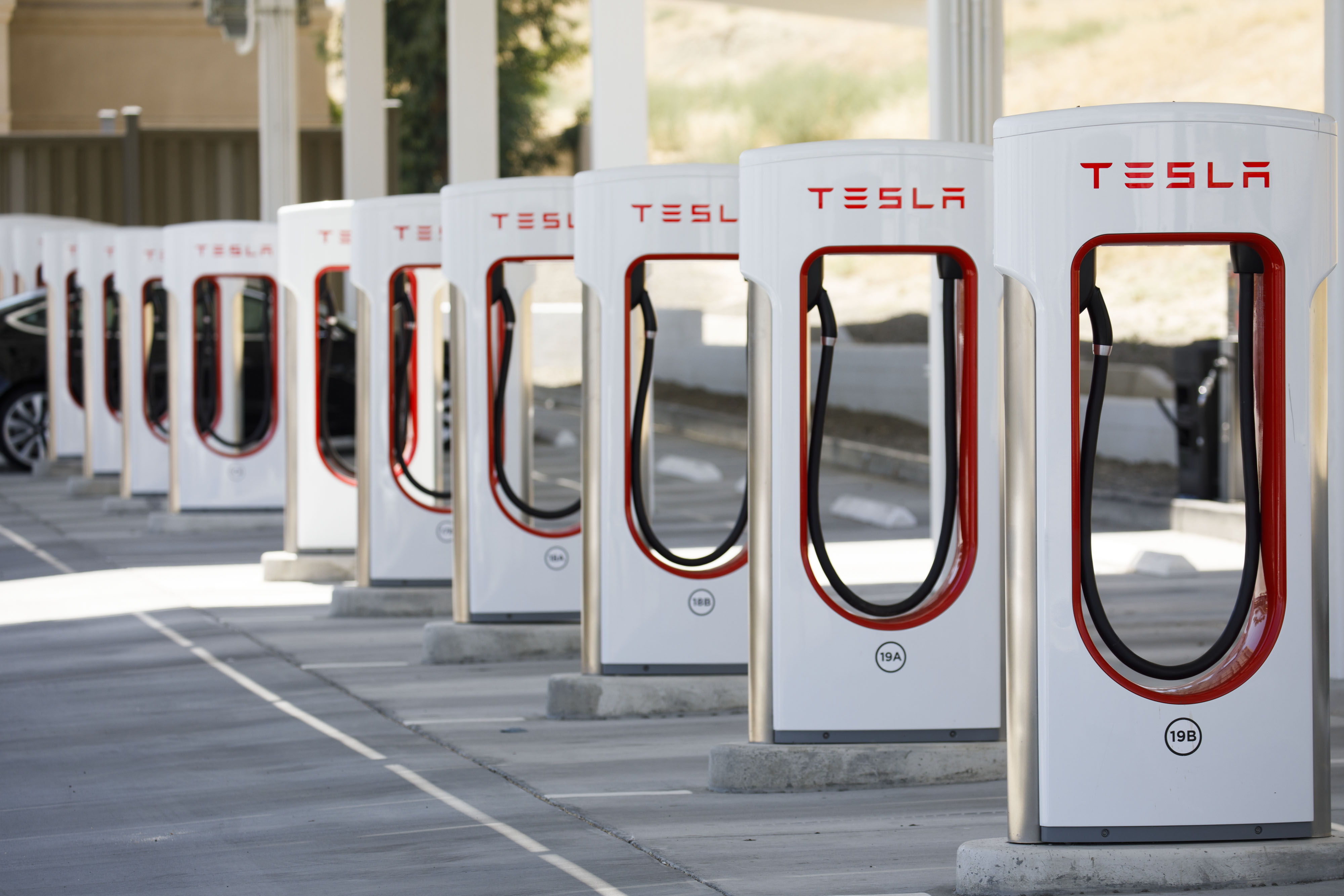 Electric vehicle charging stations stand at the Tesla Inc. Supercharger station.