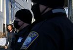 Boston Mayor Michelle Wu is met by police officers as she leaves her home in January 2022.