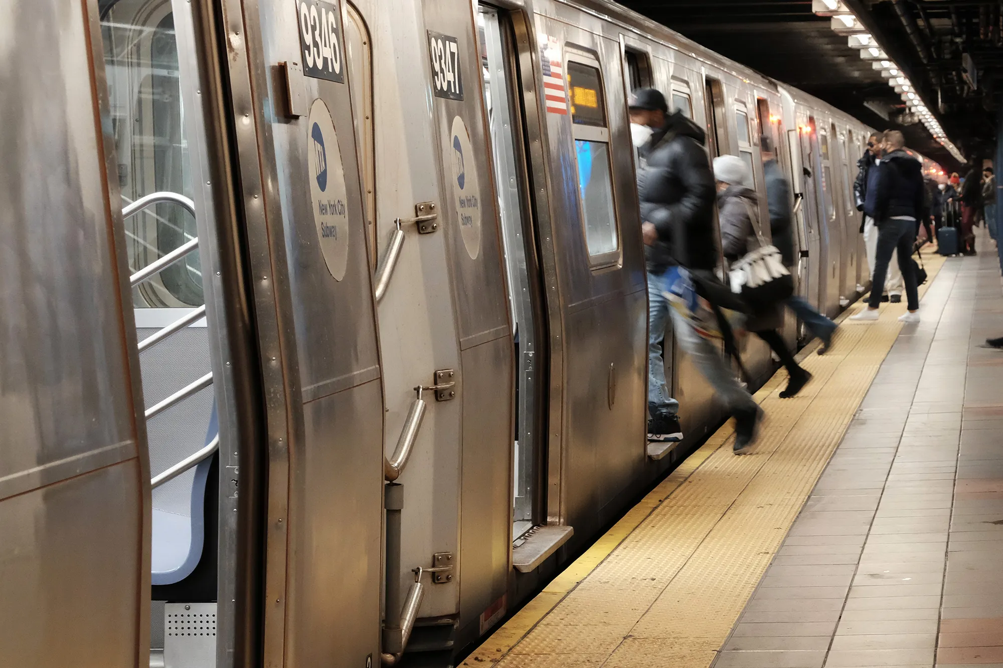 People board a subway train in New York on Jan. 19.