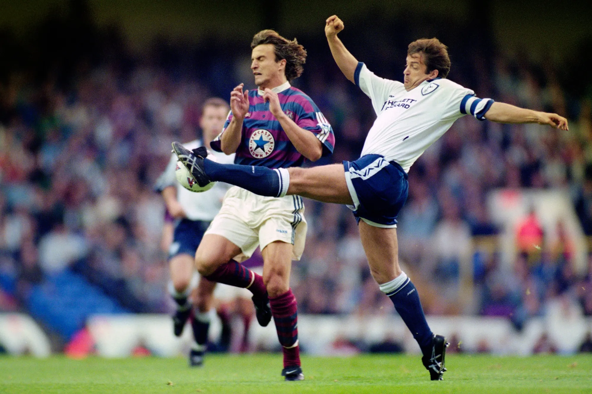Newcastle's David Ginola is tackled by Gary Mabbutt of Tottenham Hotspur.