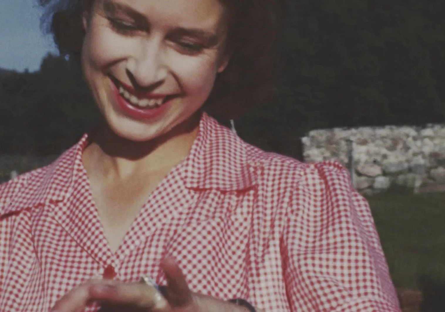 An image taken from the video 'Elizabeth: The Unseen Queen' of then Princess Elizabeth showing off her new engagement ring soon after Prince Philip's marriage proposal at Balmoral in 1946. A new documentary set to be released will reveal unseen footage of Queen Elizabeth II. The BBC has been given broad access to a huge archive of homemade films shot by the Queen, her parents and her husband, the Duke of Edinburgh. The film is being made in conjunction with upcoming celebrations for the Queen's Platinum Jubilee. (The Royal Collection via BBC Studios via AP)