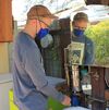Brad Lancaster, a water harvesting activist, fills a cup with filtered rainwater collected from his roof.