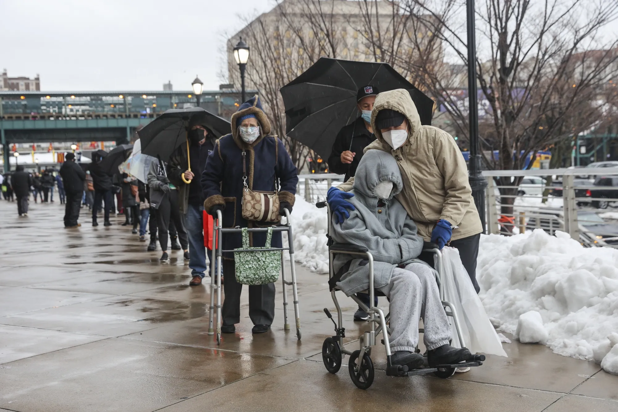 People wearing protective masks line up outside a Covid-19 vaccination hub inside Yankee Stadium in the Bronx borough of New York on&nbsp;Feb. 5.