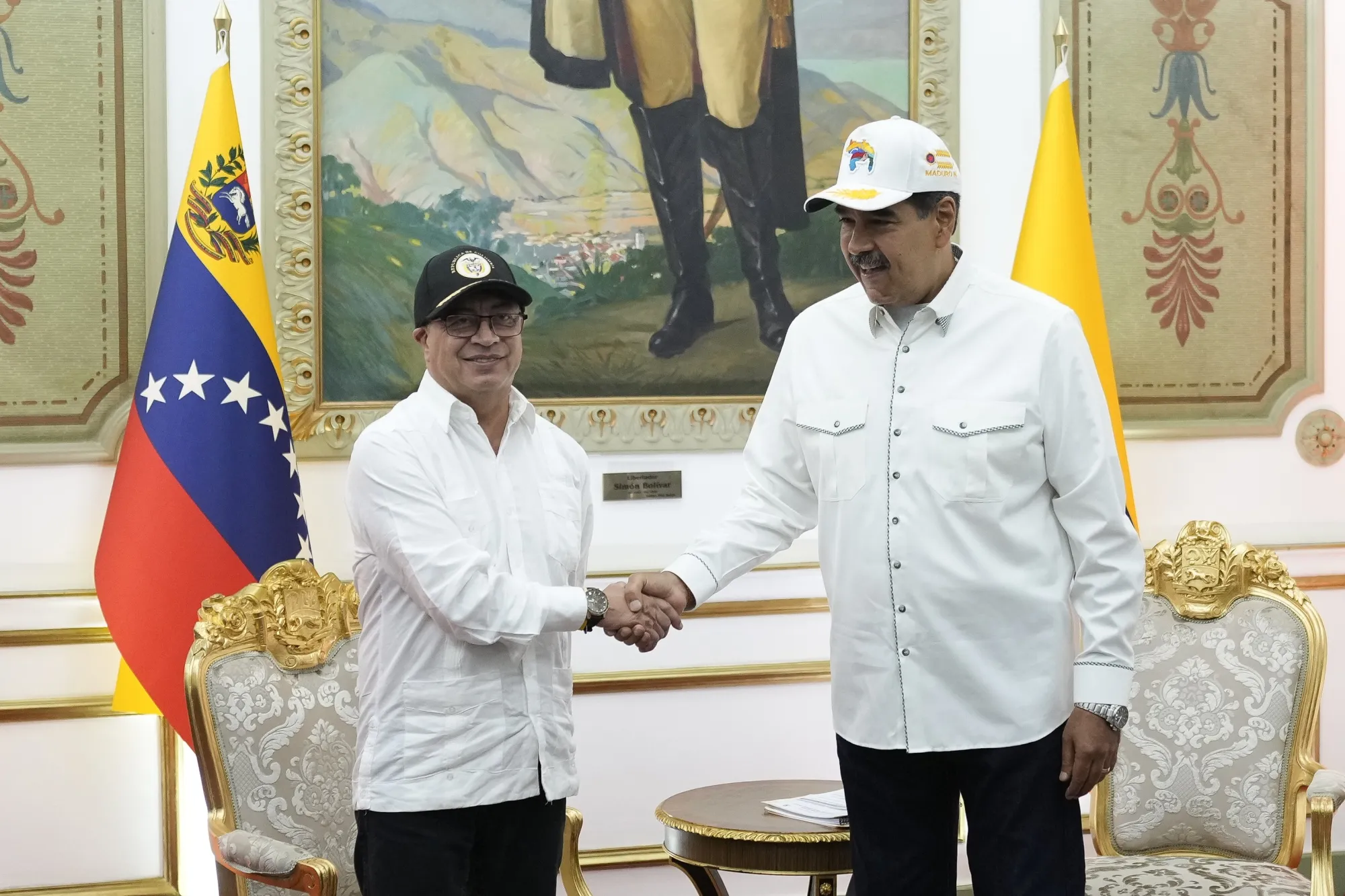Nicolas Maduro, Venezuela’s president, right, and Gustavo Petro, Colombia’s president, shake hands at Miraflores Palace in Caracas, Venezuela, on Tuesday, April 9, 2024. 