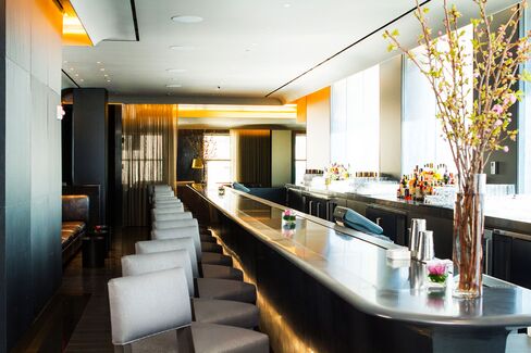 St. Cloud's indoor black corian stone-topped bar stretches 35 feet and is up-lit with golden LED lights.