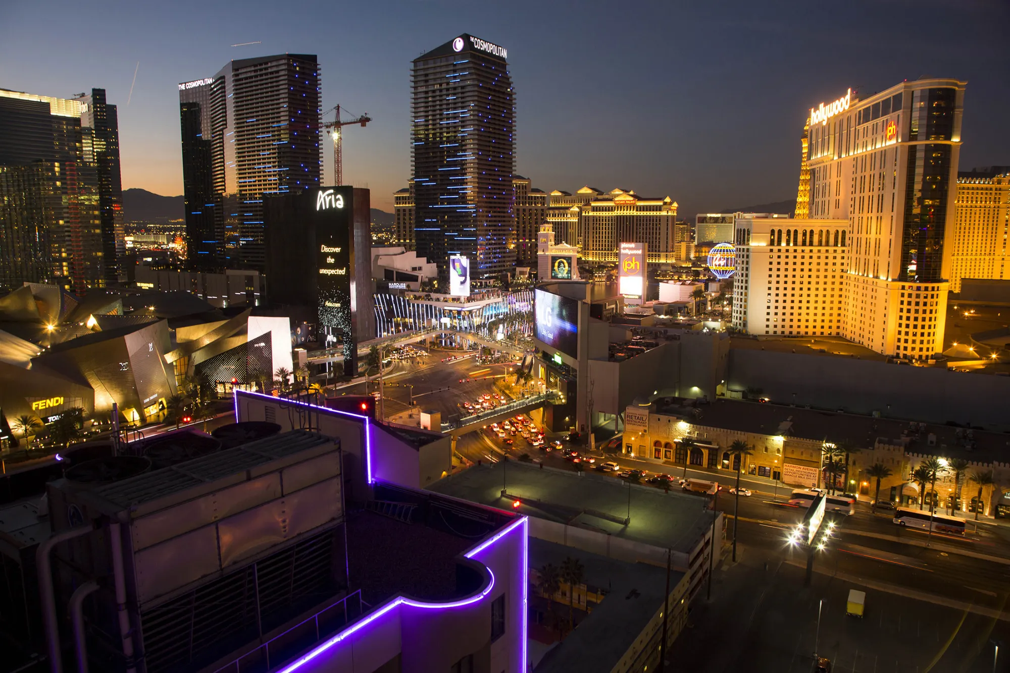 Hotels, casinos, and stores stand illuminated along The Strip at dusk in Las Vegas, Nevada, U.S., on Tuesday, Jan. 6, 2015.
