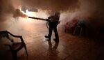 A Health Ministry employee fumigates a home against the Aedes aegypti mosquito to prevent the spread of the Zika virus in Soyapango, 6 kilometers east of San Salvador, on Jan. 21.