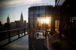 Guests attend a pool party in the penthouse apartment at 50 United Nations Plaza in New York, U.S., on Tuesday, June 07, 2016.