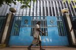 A pedestrian walks past the gate of the Tata Steel&nbsp;building in Kolkata, India.
