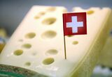 A Swiss flag is seen in a piece of Emmenthaler cheese