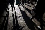 Pedestrians walk along Wall Street near the New York Stock Exchange (NYSE) in New York, U.S., on Monday, Oct. 31, 2016. U.S. stocks rose from a six-week low amid an increase in deal activity as traders assessed the outlook for the presidential election and interest rates in the world's largest economy. Photographer: Michael Nagle/Bloomberg