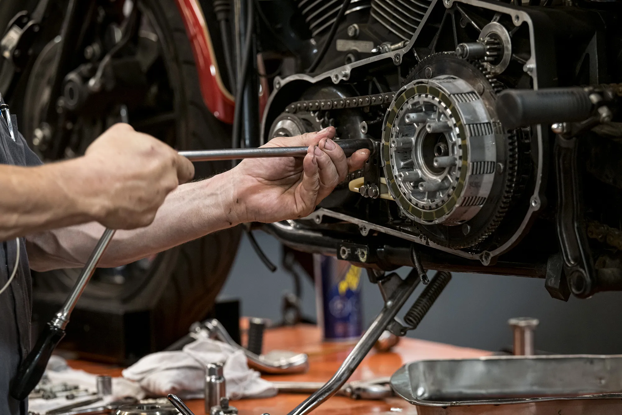 A worker uses a socket wrench to repair a motorcycle&nbsp;in Oakland, California.