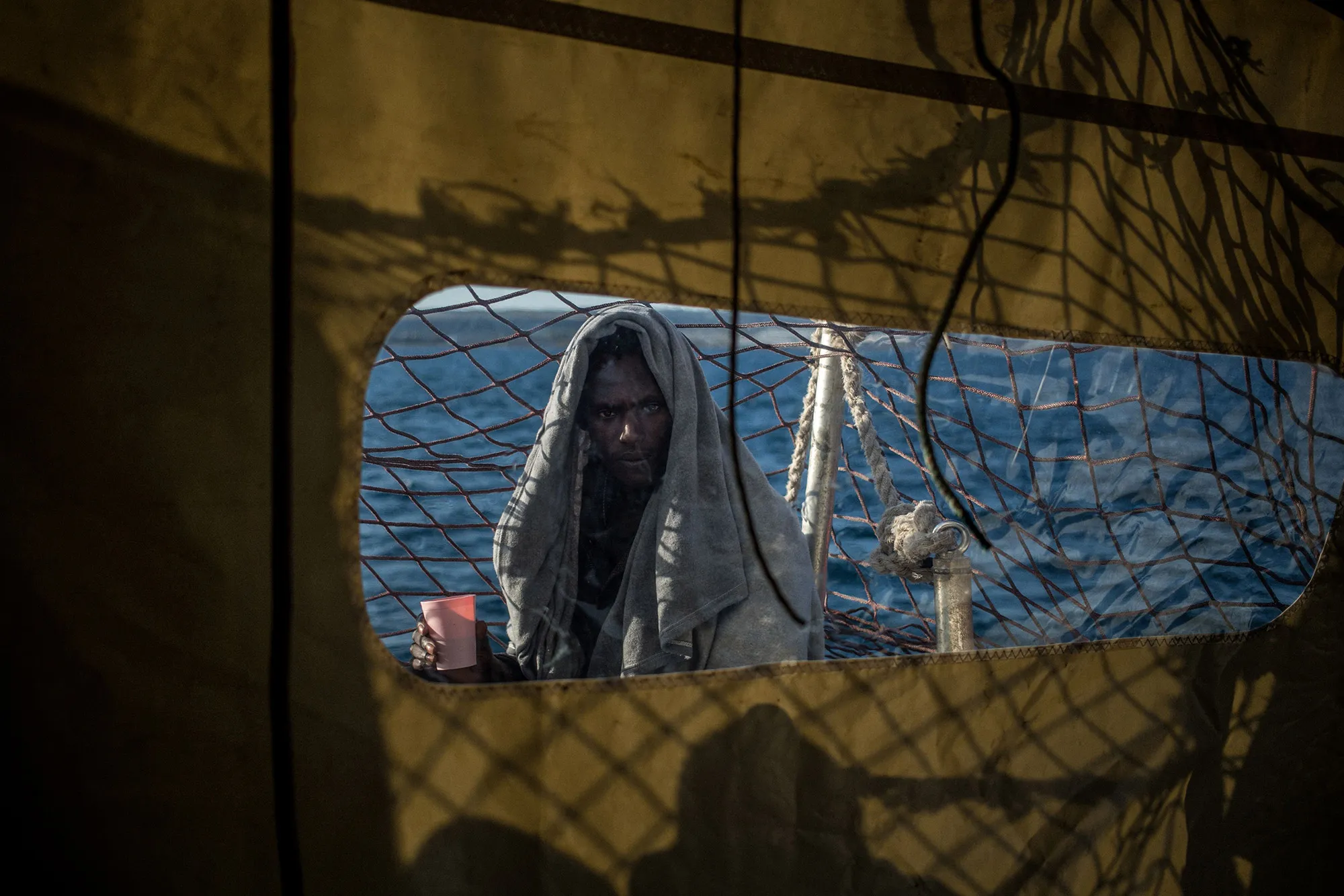 A migrant, part of a group of 47 including minors, on a rescue vessel anchored off Syracuse, Sicily.&nbsp;