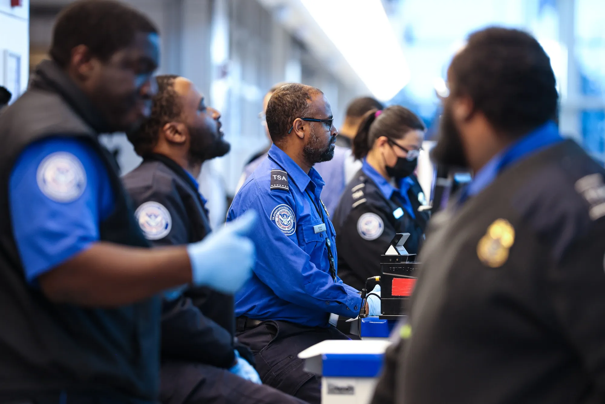 Transportation Security Administration agents screen travelers at Ronald Reagan Washington National Airport in January.