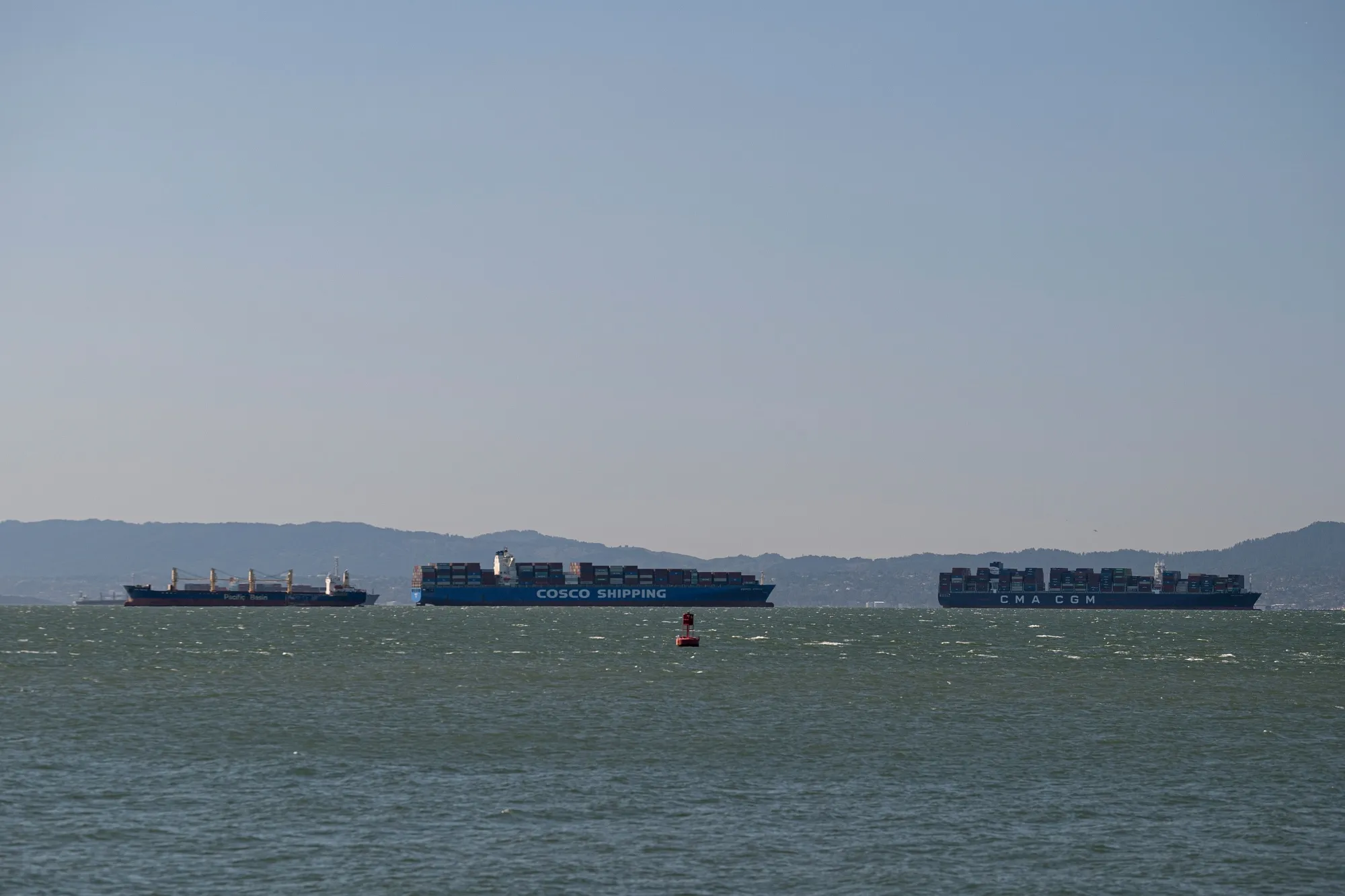 Container ships in the San Francisco Bay near the Port of Oakland in Oakland, California, on March 23.