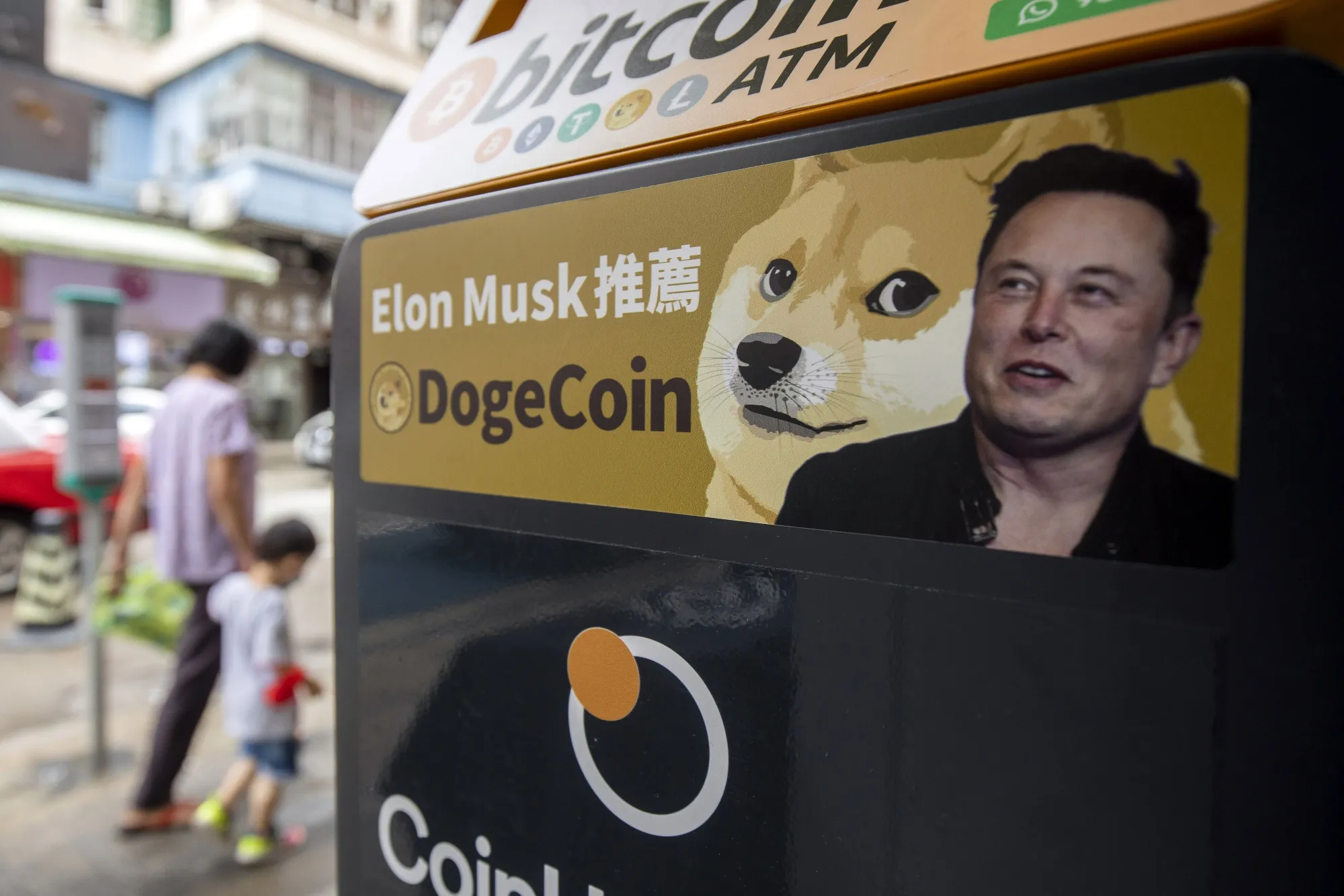 A sticker advertising Dogecoin on a cryptocurrency ATM at a laundromat in Hong Kong.