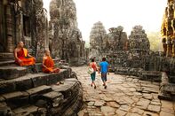 Couple visiting Buddhist temple, Angkor, Siem Reap, Cambodia