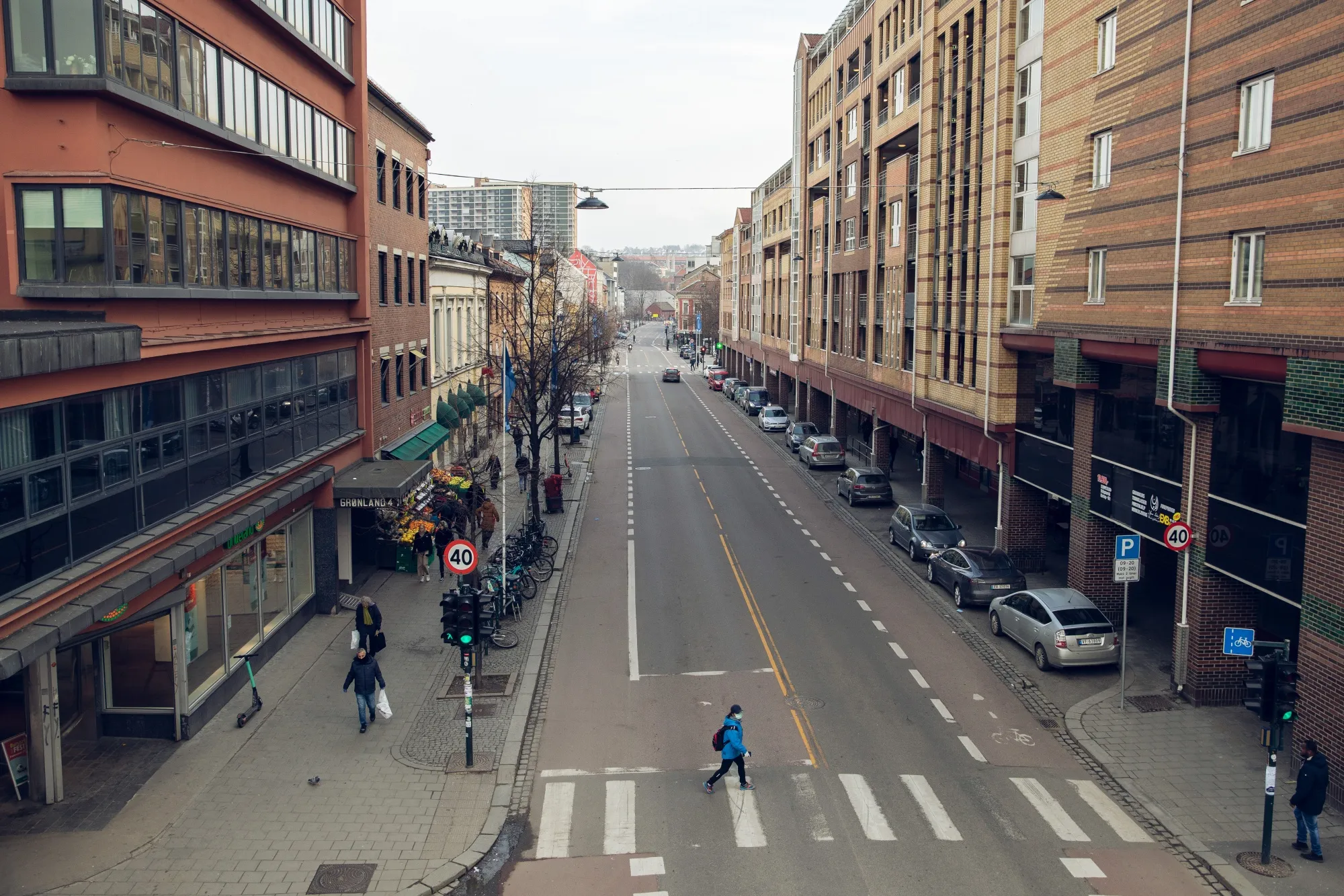 Pedestrians shop at grocery store in Oslo, on March 25.