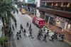 Riot police walk across Hennessy Road during a protest in the Wan Chai district of Hong Kong, China, on Sunday, Oct. 6, 2019. Violence escalated in Hong Kong as protesters set fires and vandalized train stations and banks, pushing back against government efforts to quell demonstrations when it invoked a colonial-era emergency law.