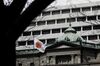 A Japanese national flag flies outside the Bank of Japan (BOJ) headquarters in Tokyo, Japan, on Monday, March 16, 2020. The Bank of Japan strengthened stimulus but stopped short of cutting its negative interest rate at an early meeting Monday after the Federal Reserve slashed its own rates to address rapidly mounting shocks from the coronavirus.