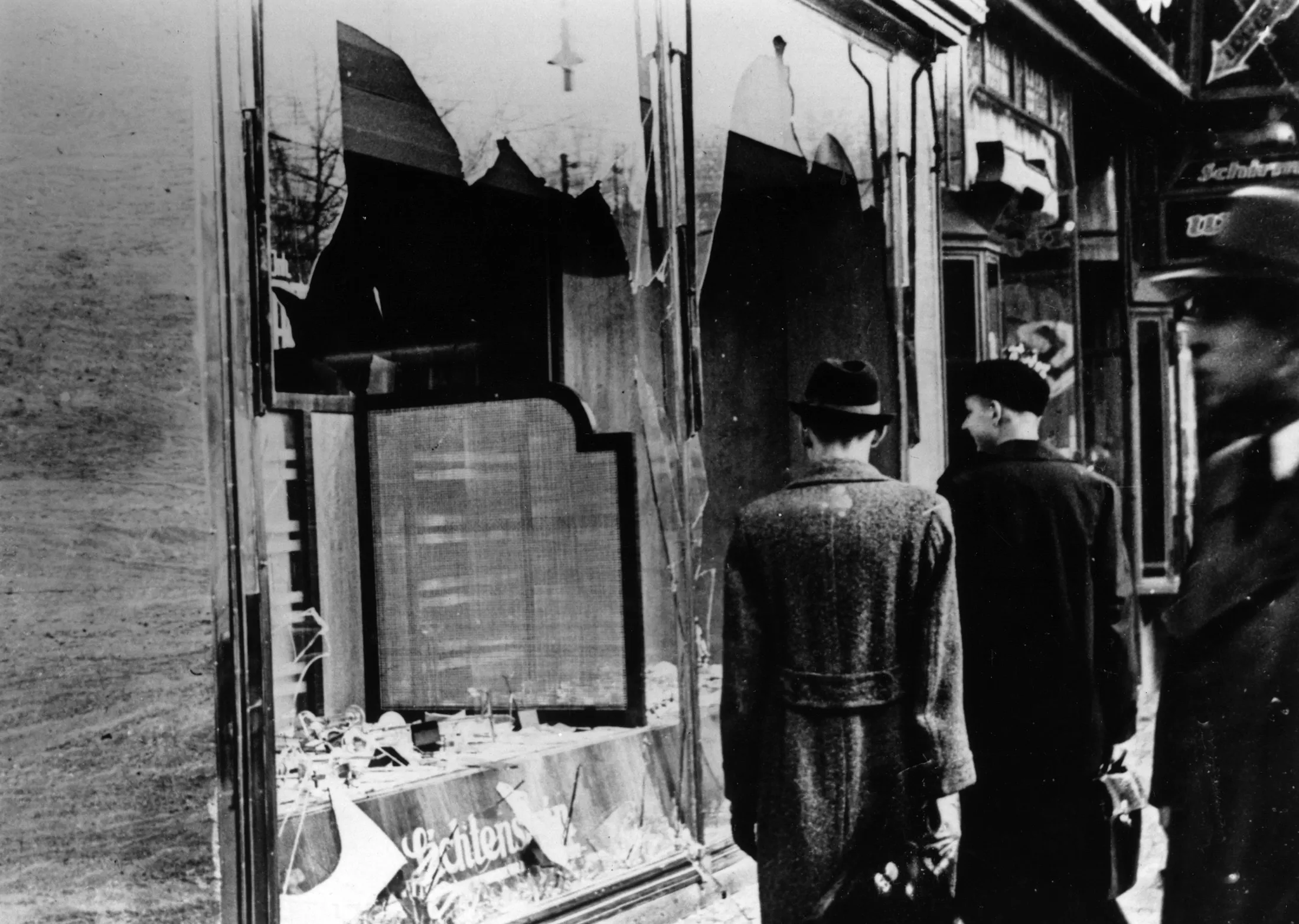 Onlookers at a smashed Jewish shop window in Berlin following riots of the night of 9th Nov.&nbsp;1938.