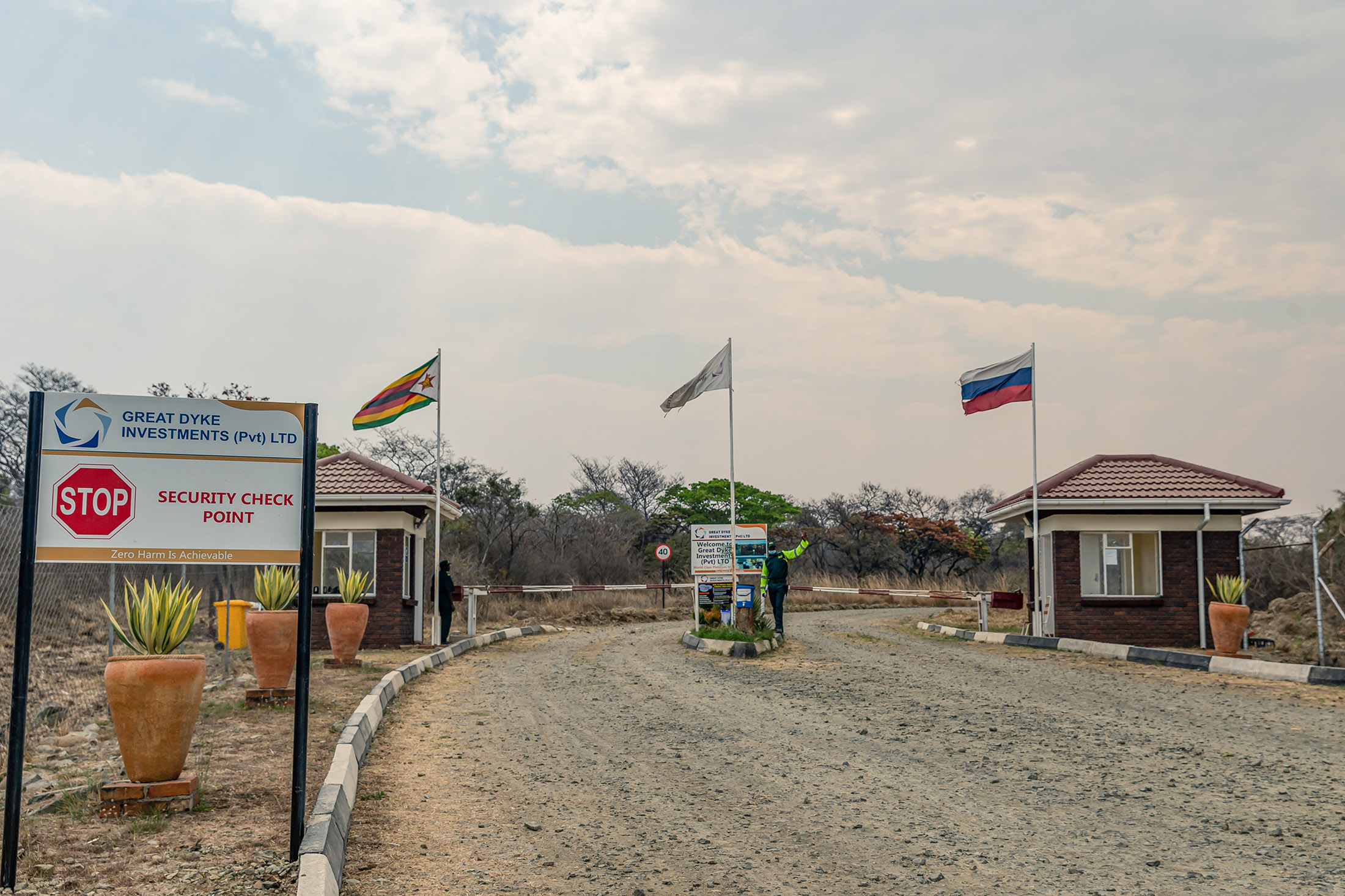 A security guard stands at the entrance gates of the Great Dyke Investments project in Zimbabwe.