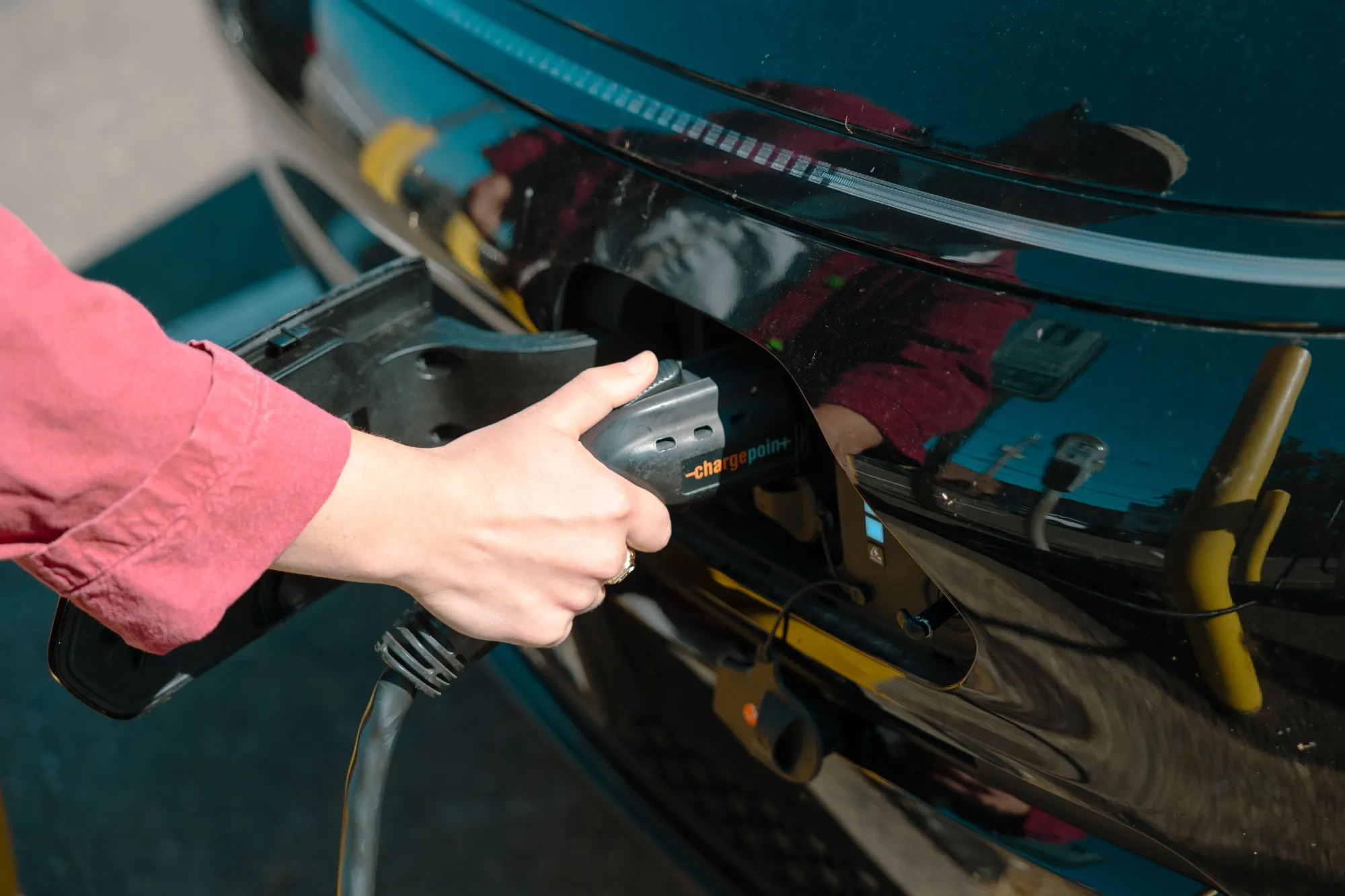 A driver unplugs an&nbsp;electric vehicle charging station in Hudson, New York.